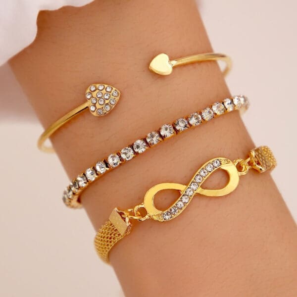 A gold bracelet with an infinity symbol and heart.