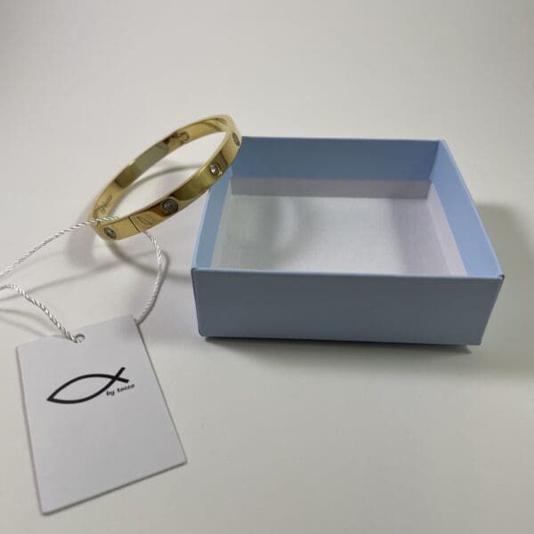 A blue box with a gold bracelet in it