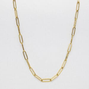 A gold chain necklace is shown on top of a white surface.