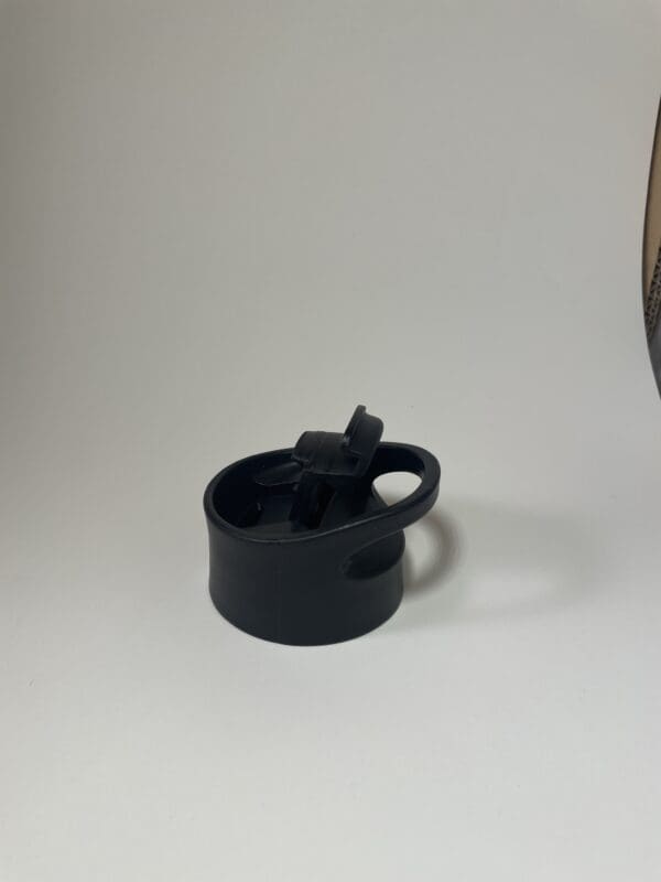 A black cup sitting on top of a table.