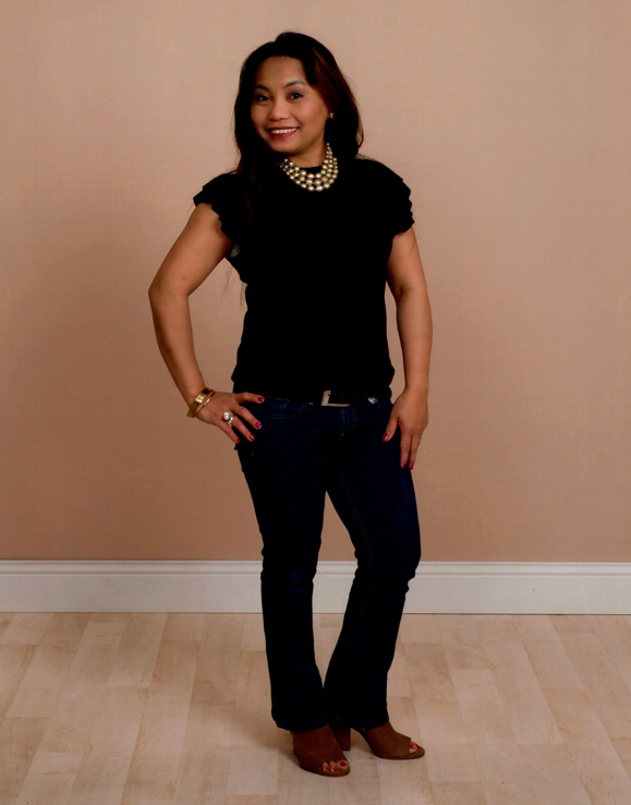 A woman standing in front of a wall.